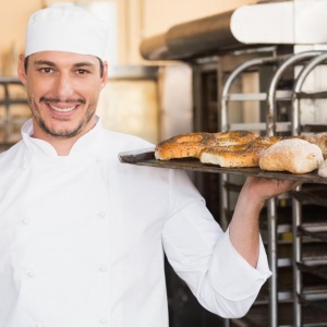 baker-holding-tray-of-bread baker-holding-tray-of-bread
